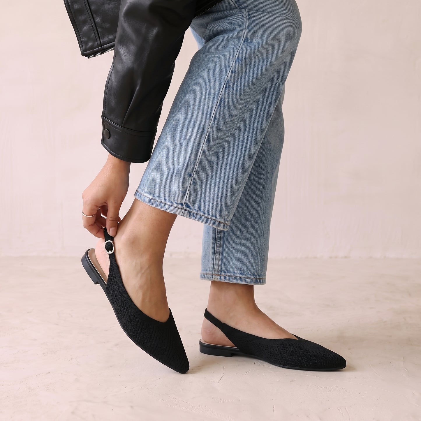 Close-up of the adjustable strap on ALBA Minuit black knit flats.