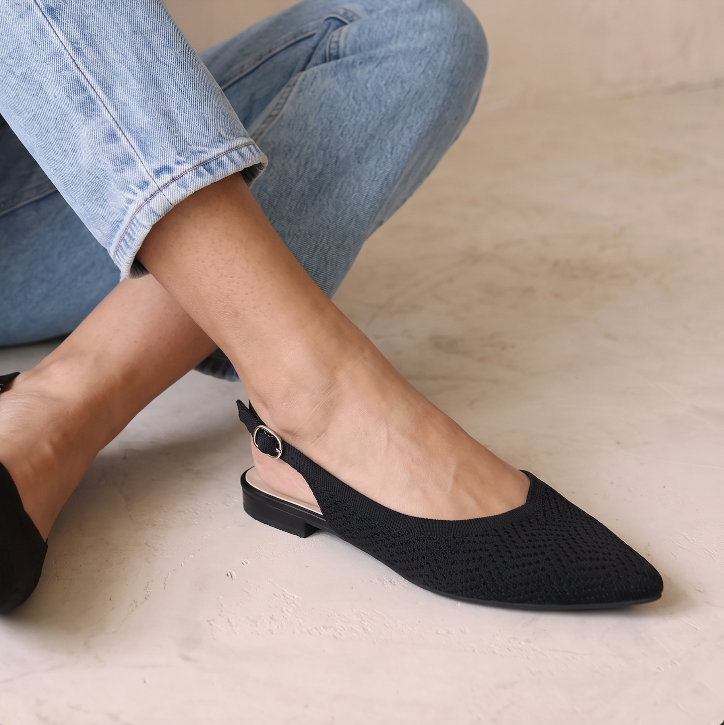 Side view of ALBA Minuit black knit slingback flats highlighting the breathable knit upper.